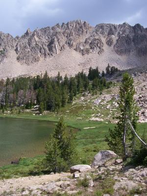 The splintered west face of Mt Frank overlooks Born Lake 9555'. Photo by Rick Baugher.