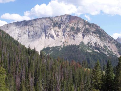 View SE to Grand Prize Peak el 9988'. Cairn placed on top 9/13/04, a rain day turning to snow up high.. Photo by Rick Baugher.